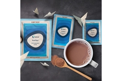 Amcor packages next to a cup of coffee.